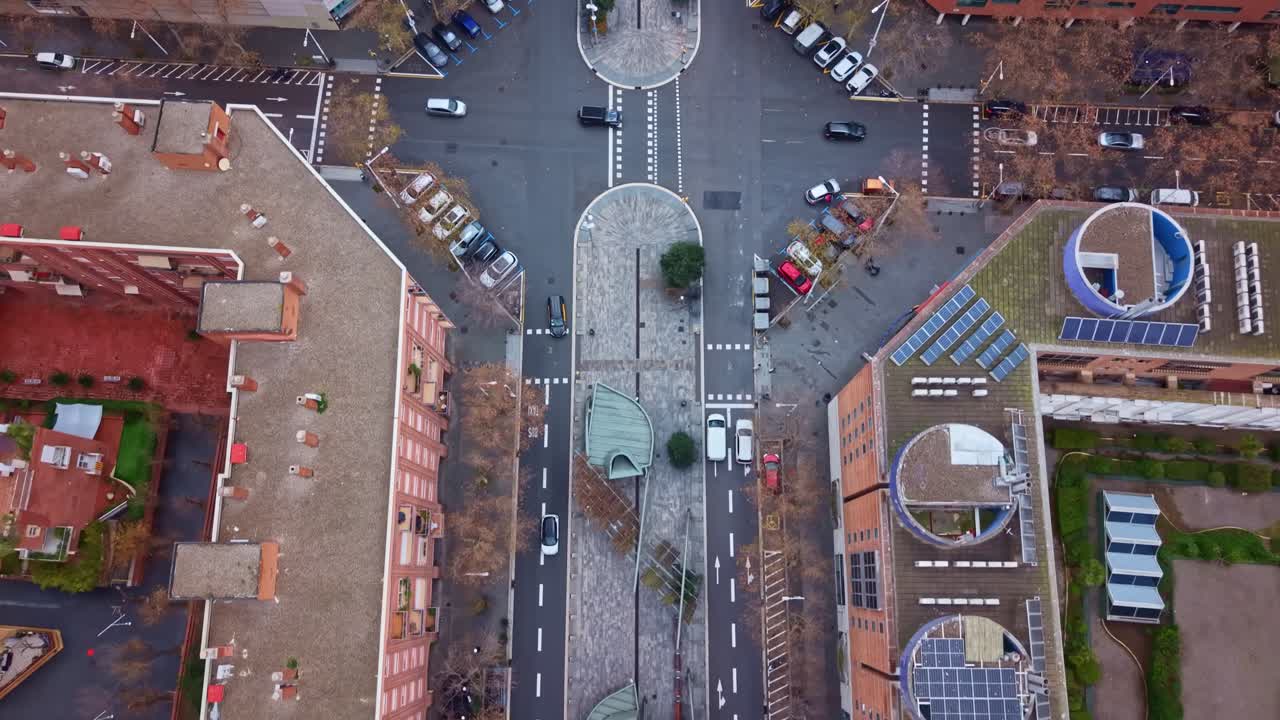 Top down view of Vila Olímpica del Poblenou district showing urban intersection, moving cars and residential buildings