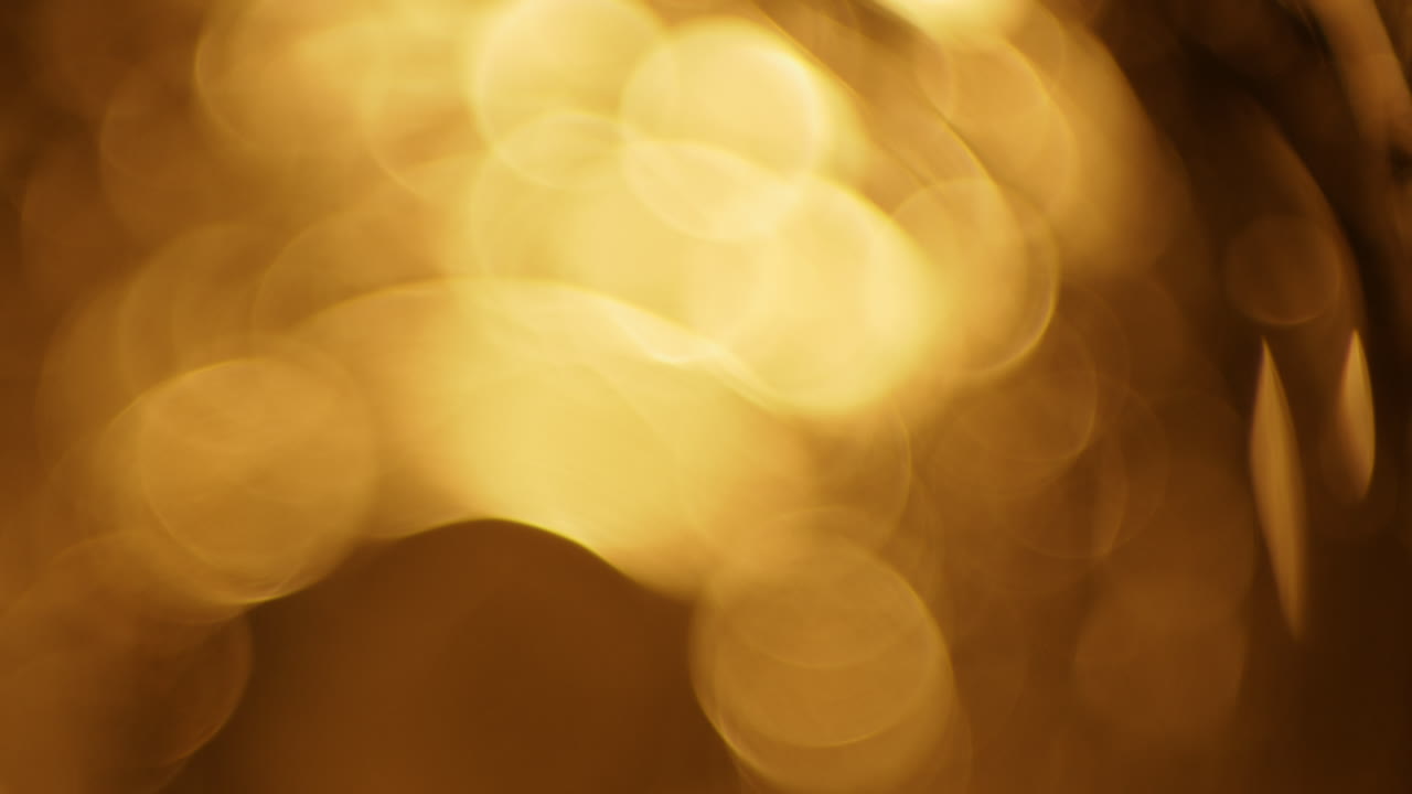 Shimmering Golden Bokeh Lights on Dark Background