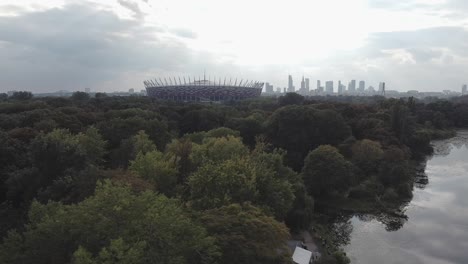 Beautiful-drone-establishing-shot-of-warsaw-national-stadium-of-poland-and-city-in-the-background