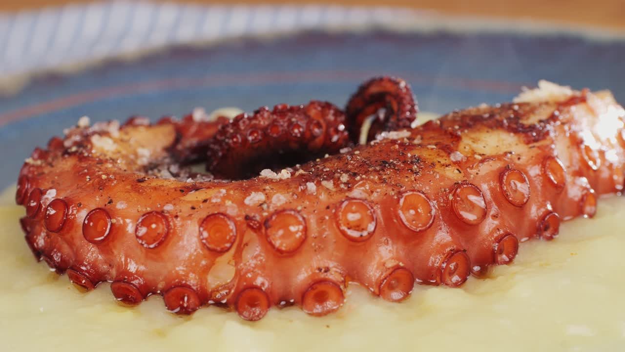 Octopus cooking, chef grill fresh octopus galician style on restaurant kitchen, healthy food, seafood cafe in spain, traditional asian japanese spanish and mediterranean dish.