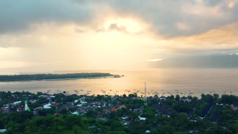 birds eye view of coastal town under cloudy sky during golden hour