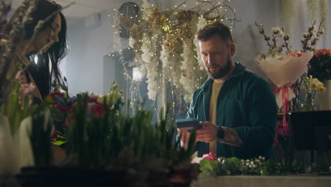 people arranging flowers in a flower shop