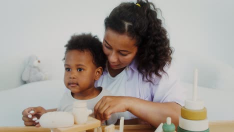mother and son playing with wooden toys