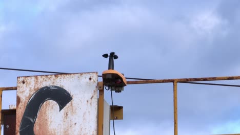 Weather-vane-measuring-the-direction-and-the-intensity-of-the-wind-on-a-crane,-aerial-close-up-view