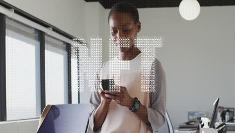 animation of nft text banner against african american woman using smartphone at office