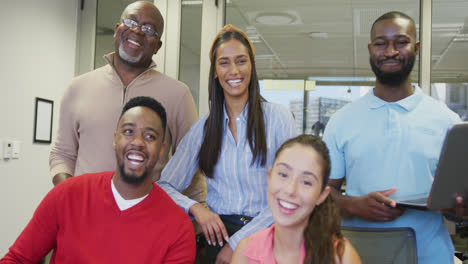 portrait of diverse male and female business colleagues smiling in office