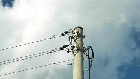 close-up of an electricity pylon against a cloudy sky