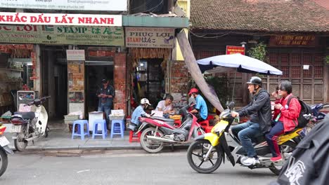 motorbikes and cars moving on a busy street