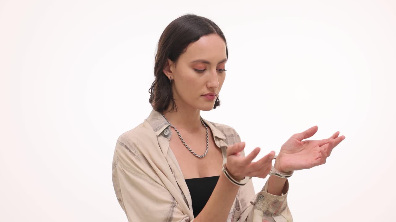 Woman with handcuffs on a white background