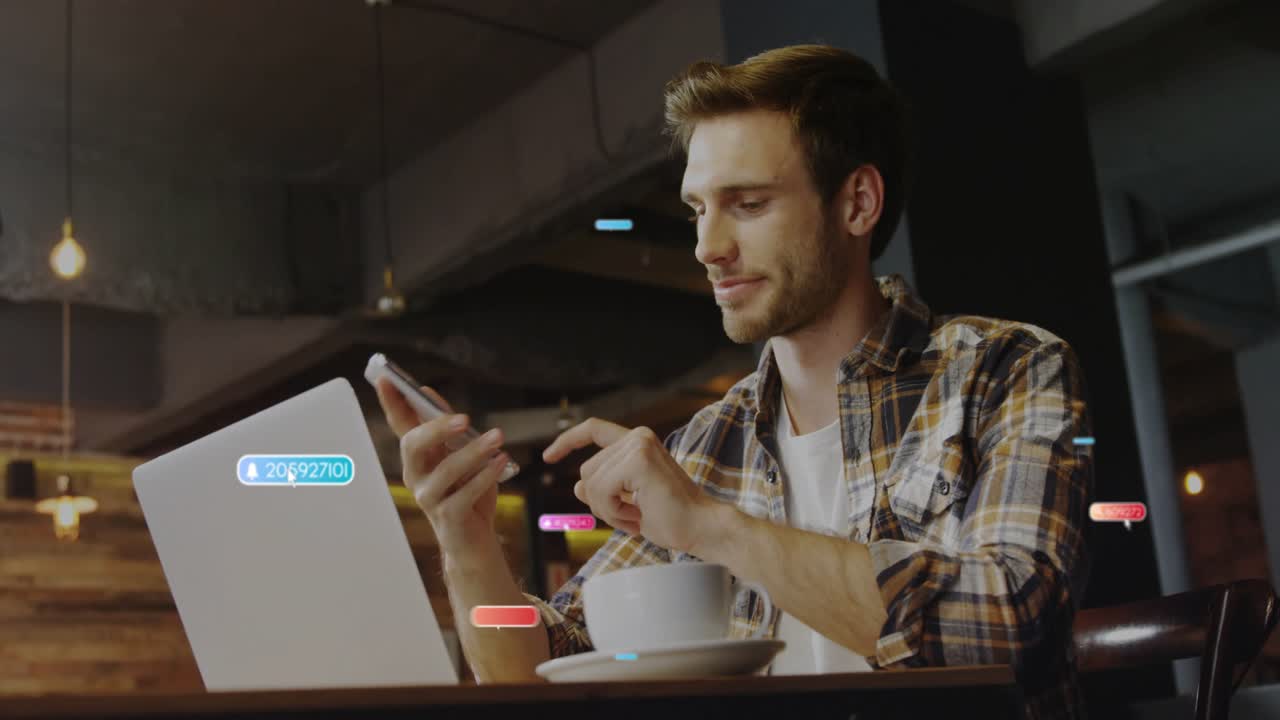 Male worker lifting smartphone in cafe, animating social media badges floating checking metrics
