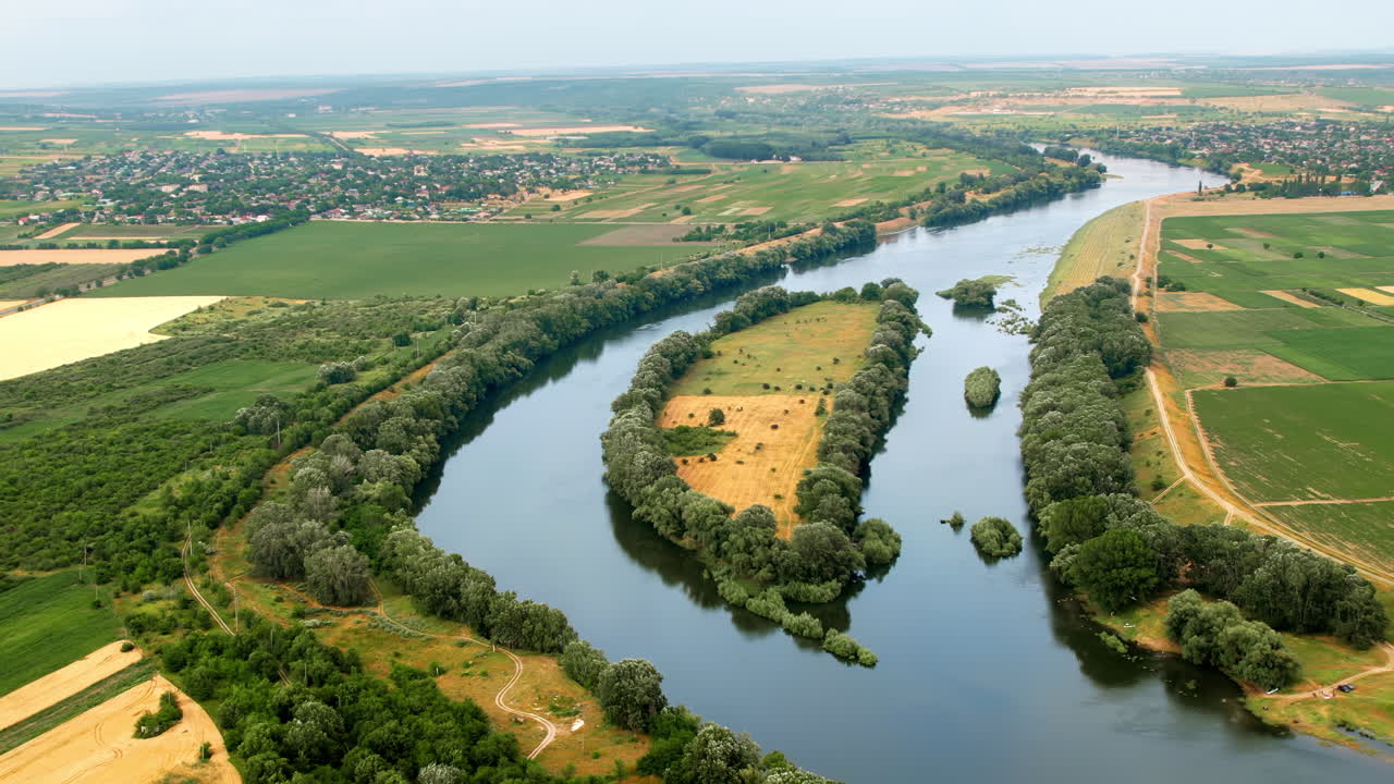 Vista aerea con drone della natura in Moldavia. Fiume Dniester con alberi rigogliosi lungo il suo corso, villaggi in lontananza e campi intorno