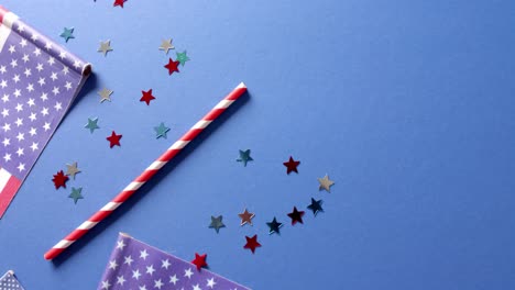 national flags of usa with stars and straw lying on blue background with copy space