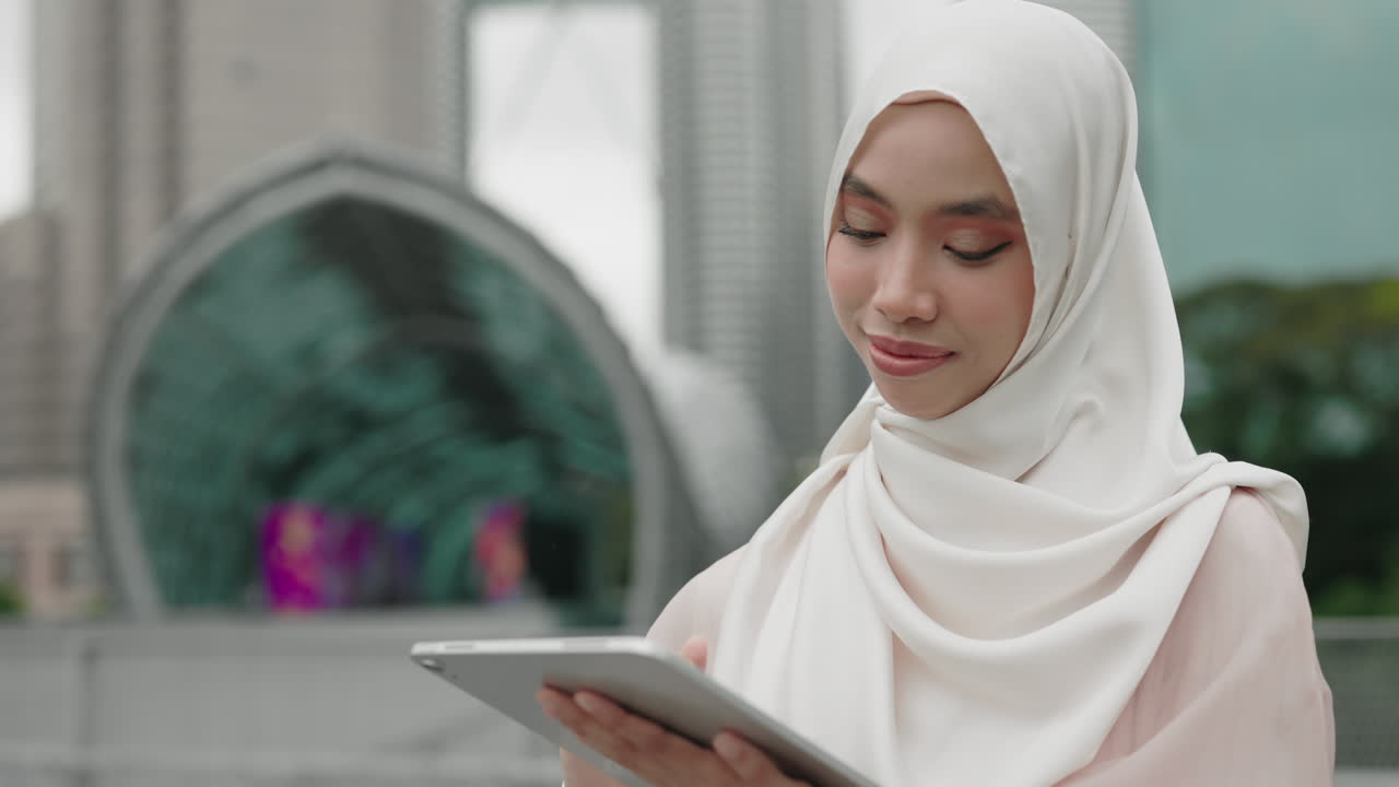 Woman using a tablet in a city