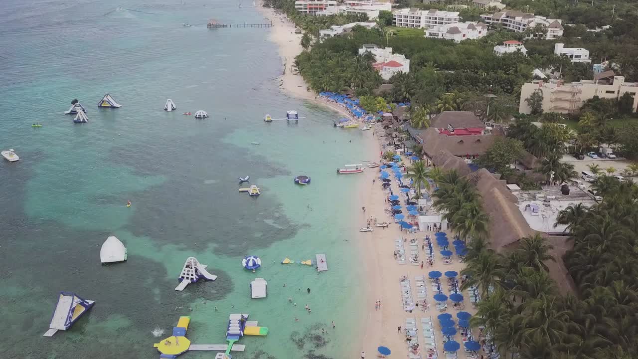 Drone footage of the beach and beach activities in Cozumel.