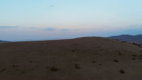 Sunset-in-the-hills-of-Northern-Kenya,-with-people-watching-the-view