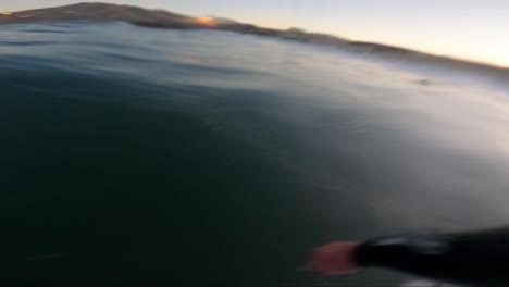 young man doing a tube and strong snap on the end at guincho surf spot in cascais