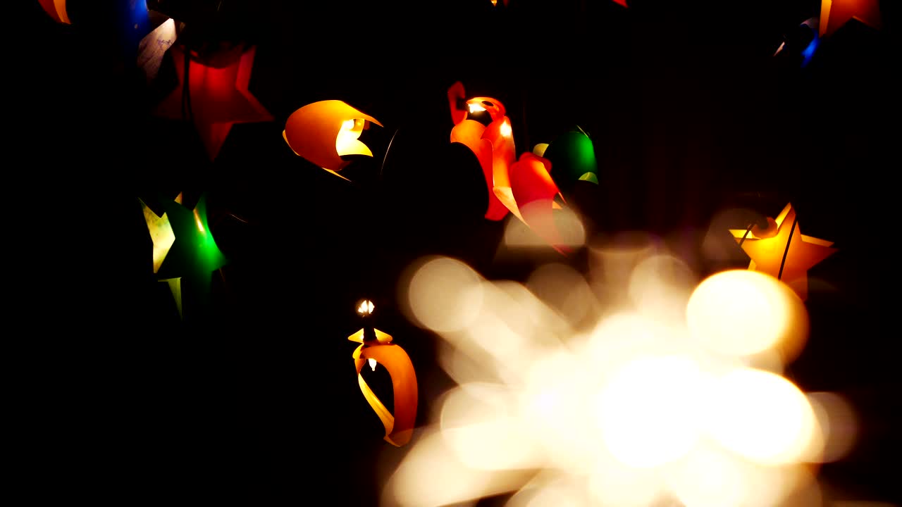 4k.Blurred fireworks  and  festive garland of small lamps