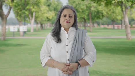 Indian-mother-looking-to-the-camera-in-park