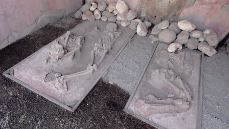 daytime, dutch angle, wide shot of skeletons at pompeii