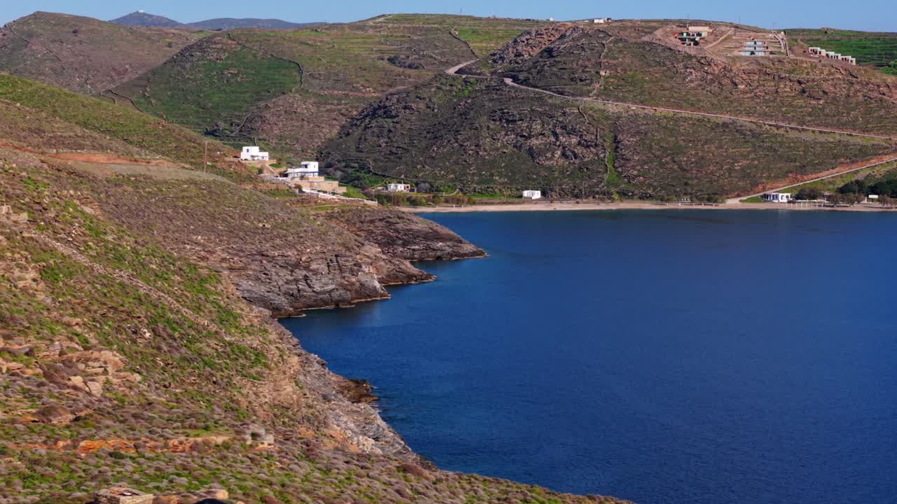 Side aerial of coastal hill terrain with sea edge visible on Kythnos Island in afternoon light, backdrop background