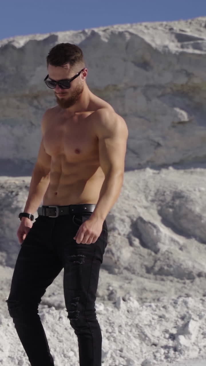 Handsome fit man posing outdoors. Topless handsome healthy athletic man with muscular body