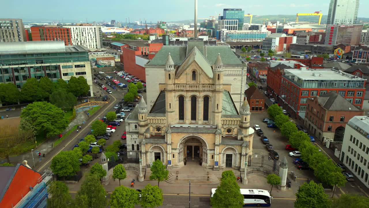 Front-on, reversing aerial video of St Anne's Cathedral in the Cathedral Quarter in Belfat City Centre, Northern Ireland on a bright and sunny day. Filmed in 4K, 60FPS and with Rec709 Color.