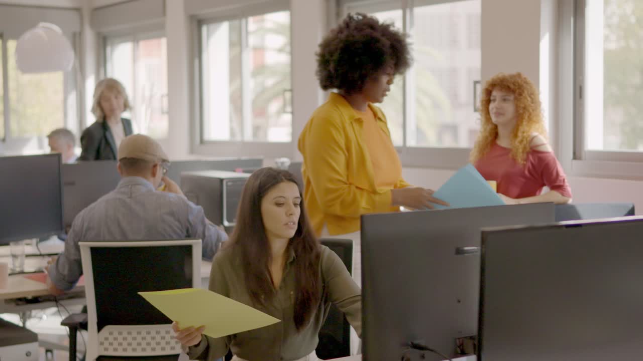 African woman arriving and sitting at a cowoking