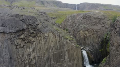 Aerial-rising-shot-of-flowing-Litlanesfoss-waterfall-in-Highlands-of-Iceland