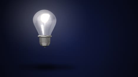 4k video of light bulb on blue background. concept of electricity.