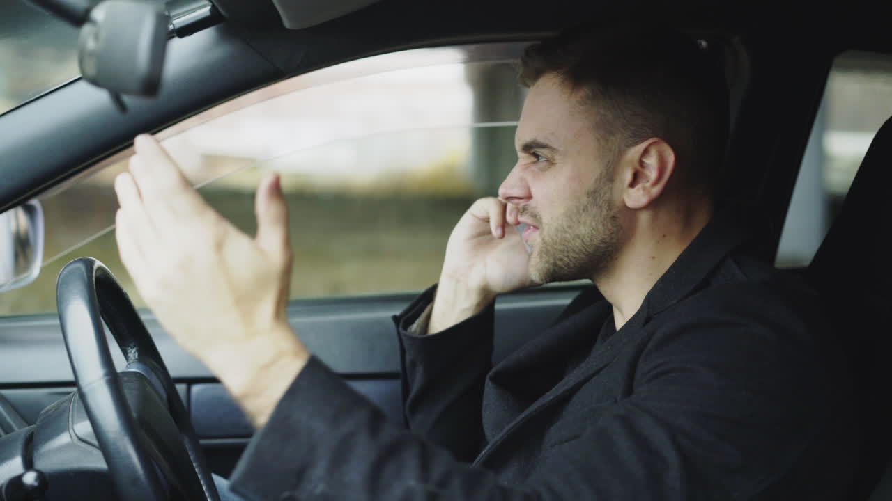 Man Driving and Arguing on Phone