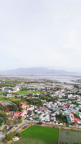 aerial vertical shot pan of city and the farms in phan rang–tháp chàm.