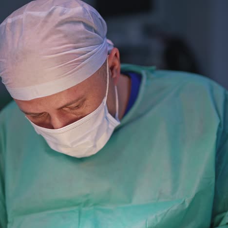 portrait of a surgeon during surgery. professional male doctor in medical mask and uniform performing plastic operation to a patient in hospital. close-up