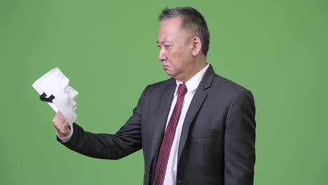 mature japanese businessman with white mask as concept