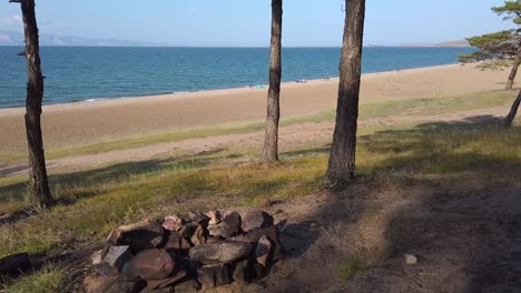 Saraiskii-Bay-Beach-fire-pit-on-Olkhon-Island,-Lake-Baikal,-beach-reveal