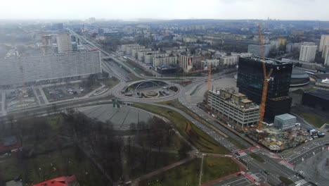 Aerial-Over-Big-City-With-Building-in-Construction-And-Empty-Roads