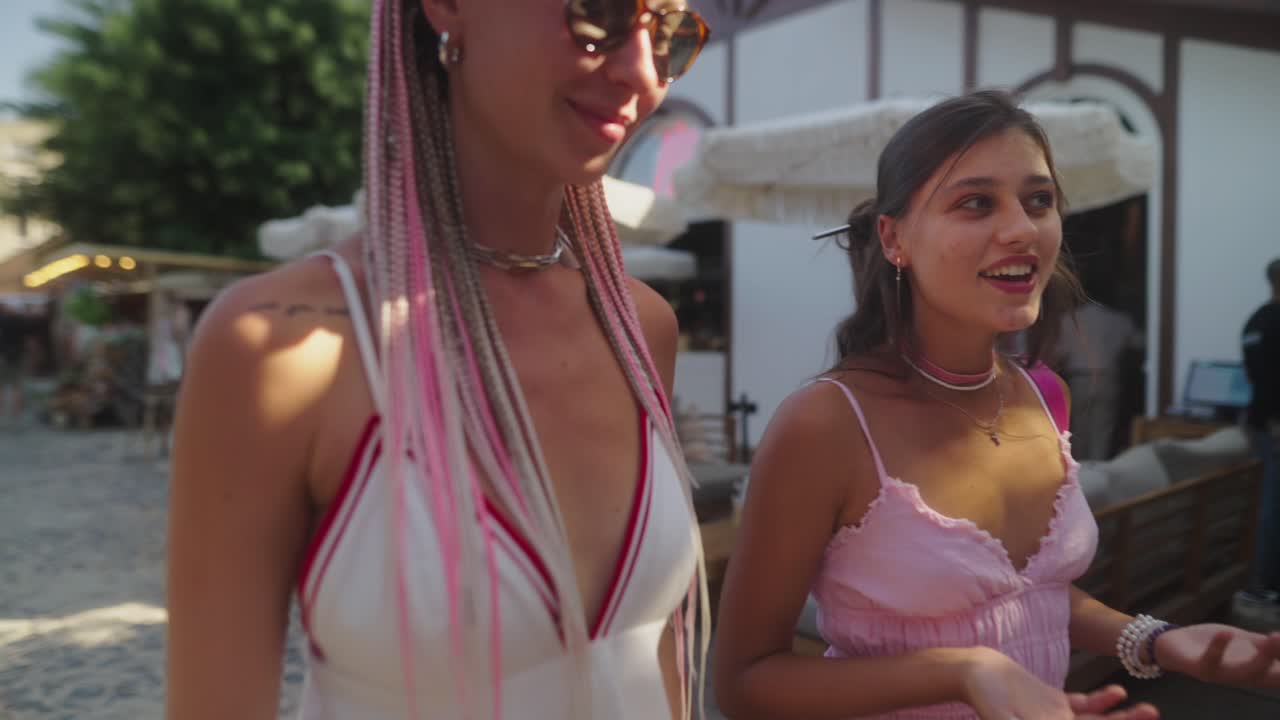 Two stylish women walking on a cobblestone street