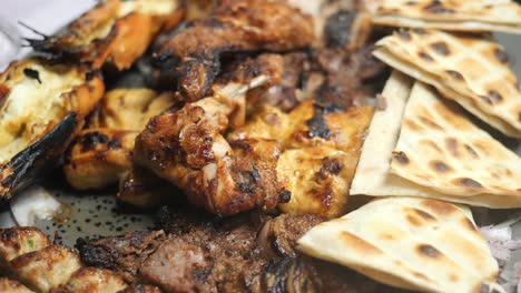 seekh kabab, bread, and sauce on a plate