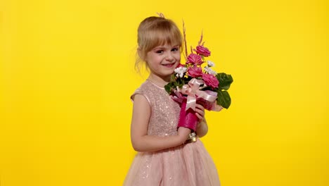 Little-child-girl-with-fashion-makeup-standing-with-bouquet-of-flowers-isolated-on-yellow-background