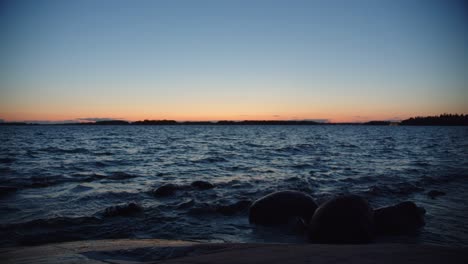 waves crashing on the rocks at sundown