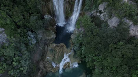 Drone-video-of-a-crane-plane-of-ascent-and-rear-cenital-over-the-Manojlovac-waterfall-on-the-Krka-river-in-Croatia-ending-with-the-horizon-on-the-mountain