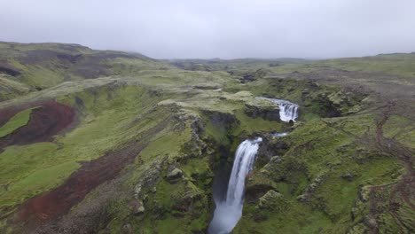 aerial over the famous natural landmark and tourist attraction of skogafoss falls and fimmvorduhals trail in iceland