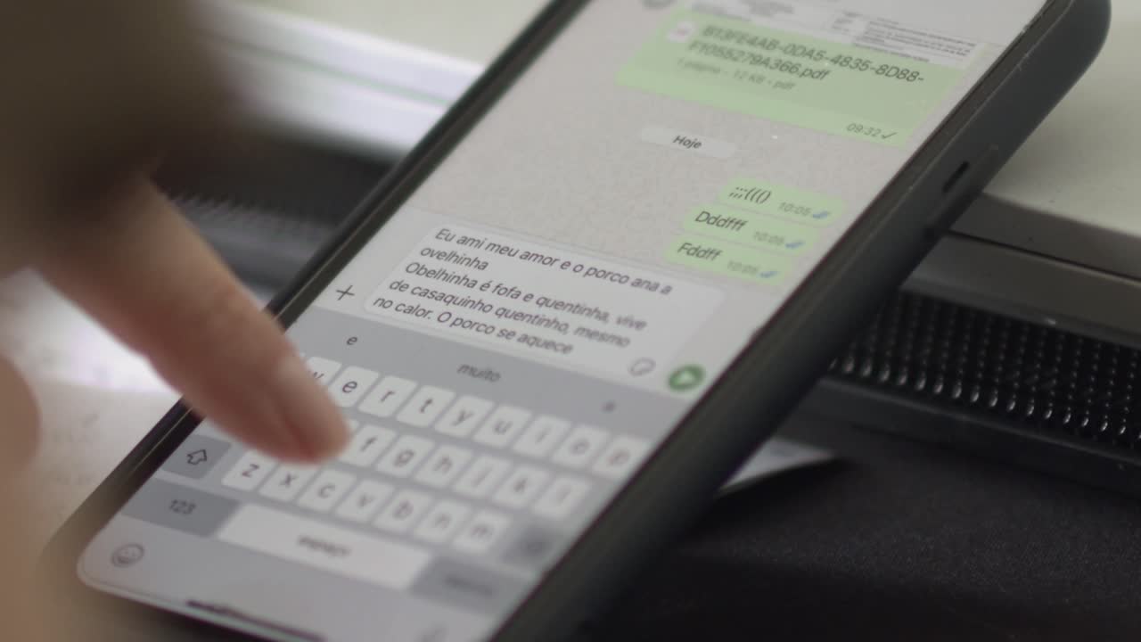 White female typing text message on cell phone with finger, closeup