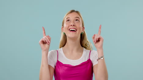 Face,-smile-and-woman-pointing-up-in-studio