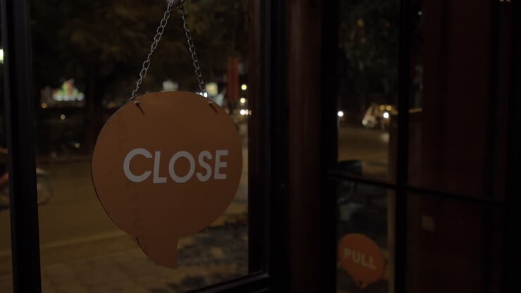 Store sign closed is turned to open at night on road background Hanoi Vietnam
