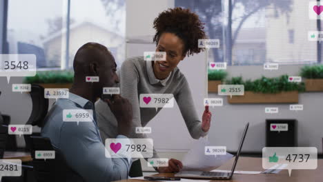 animation of social media icons falling against african american man and woman discussing at office