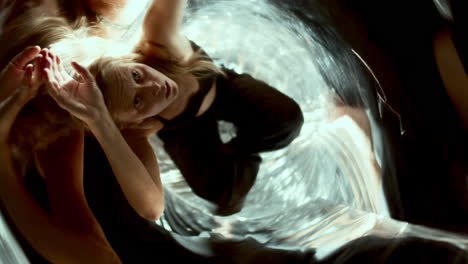 expressive woman moving gracefully in distorted mirror reflections