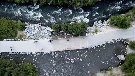 A-bird's-eye-view-of-a-timelapse-of-walkers-and-hikers-enjoying-the-view-of-Bridal-Veil-Falls-River-in-Utah