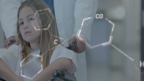 animación de estructura química sobre una niña en silla de ruedas empujada por un profesional médico