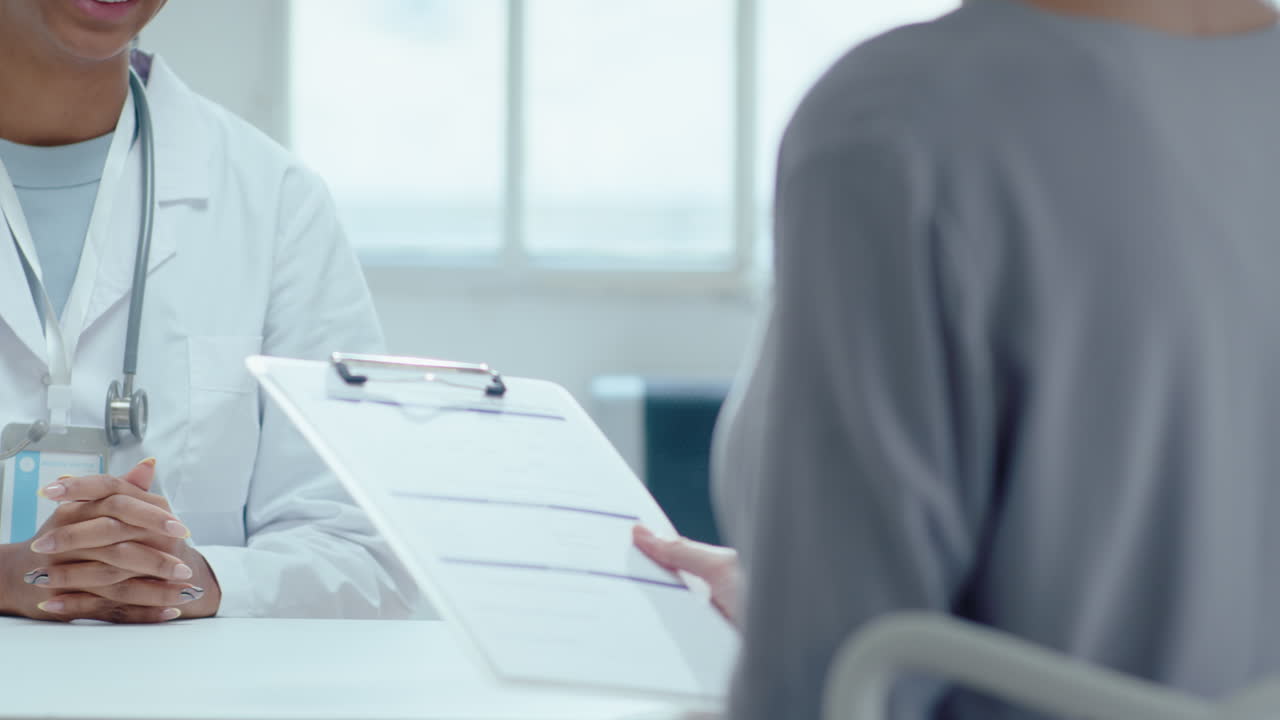 Doctor and Patient Shaking Hands after Signing Medical Agreement