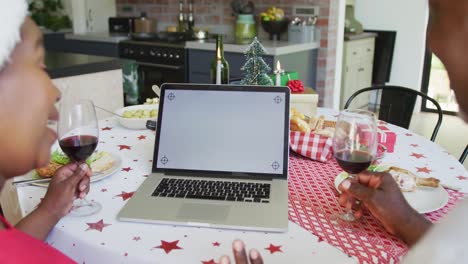 feliz pareja de ancianos afroamericanos en videollamada en computadora portátil con espacio de copia en el tiempo de navidad